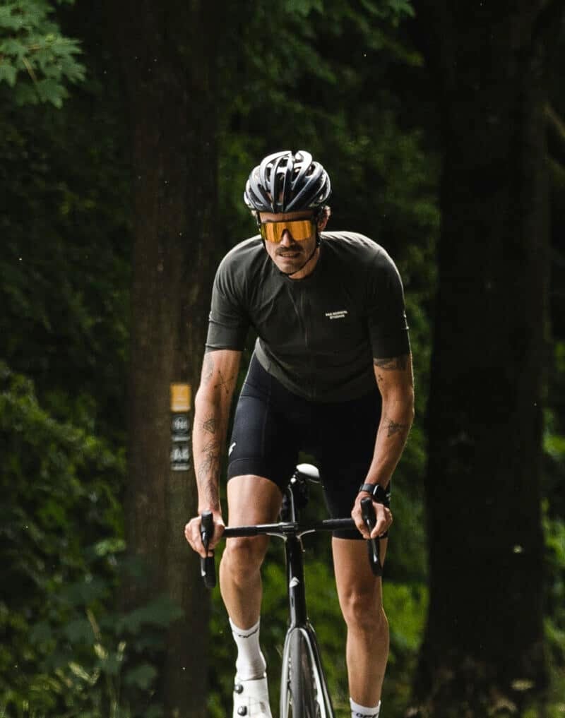A man standing on his paddles cycling